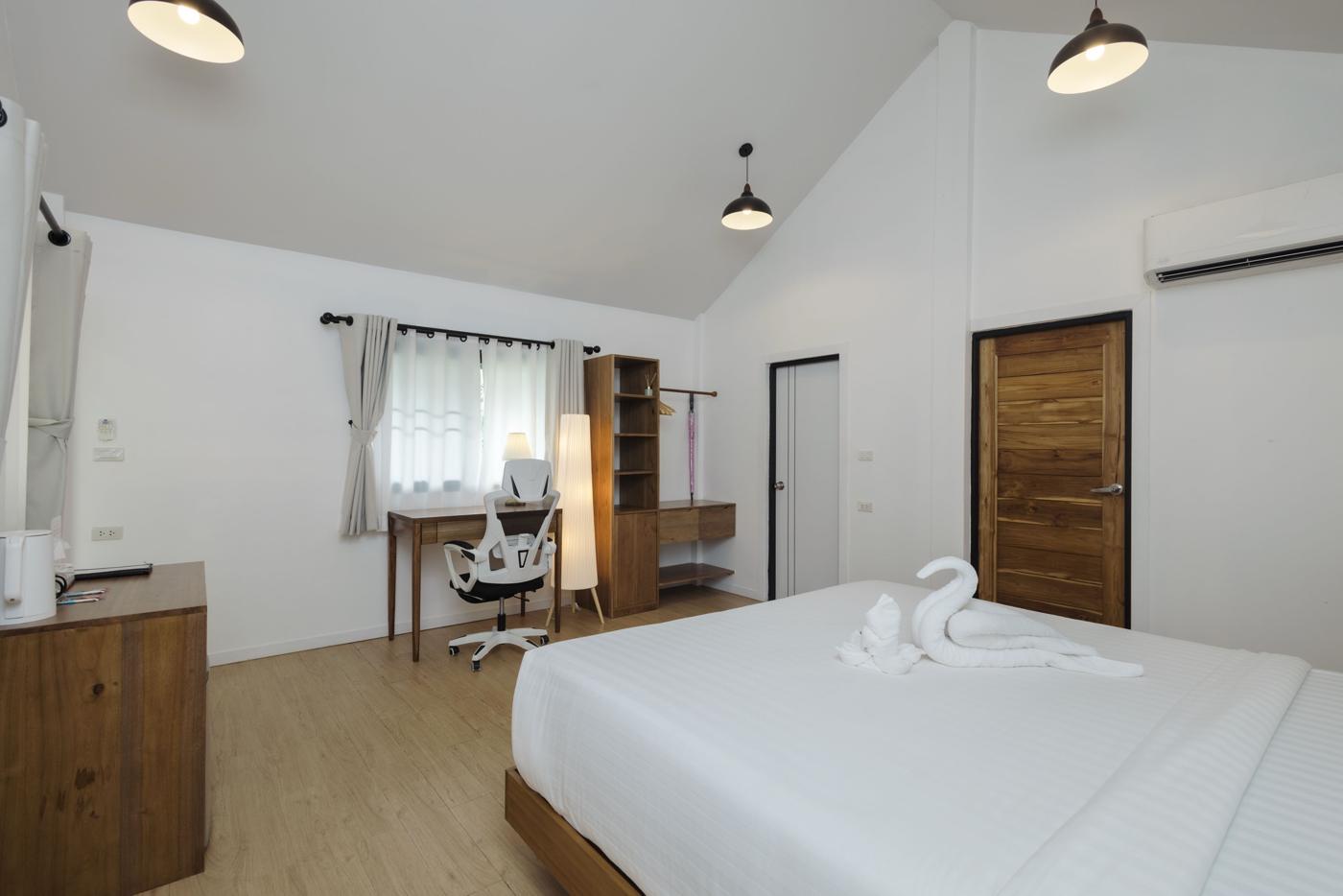 Bedroom with work desk, ergonomic chair and wardrobe