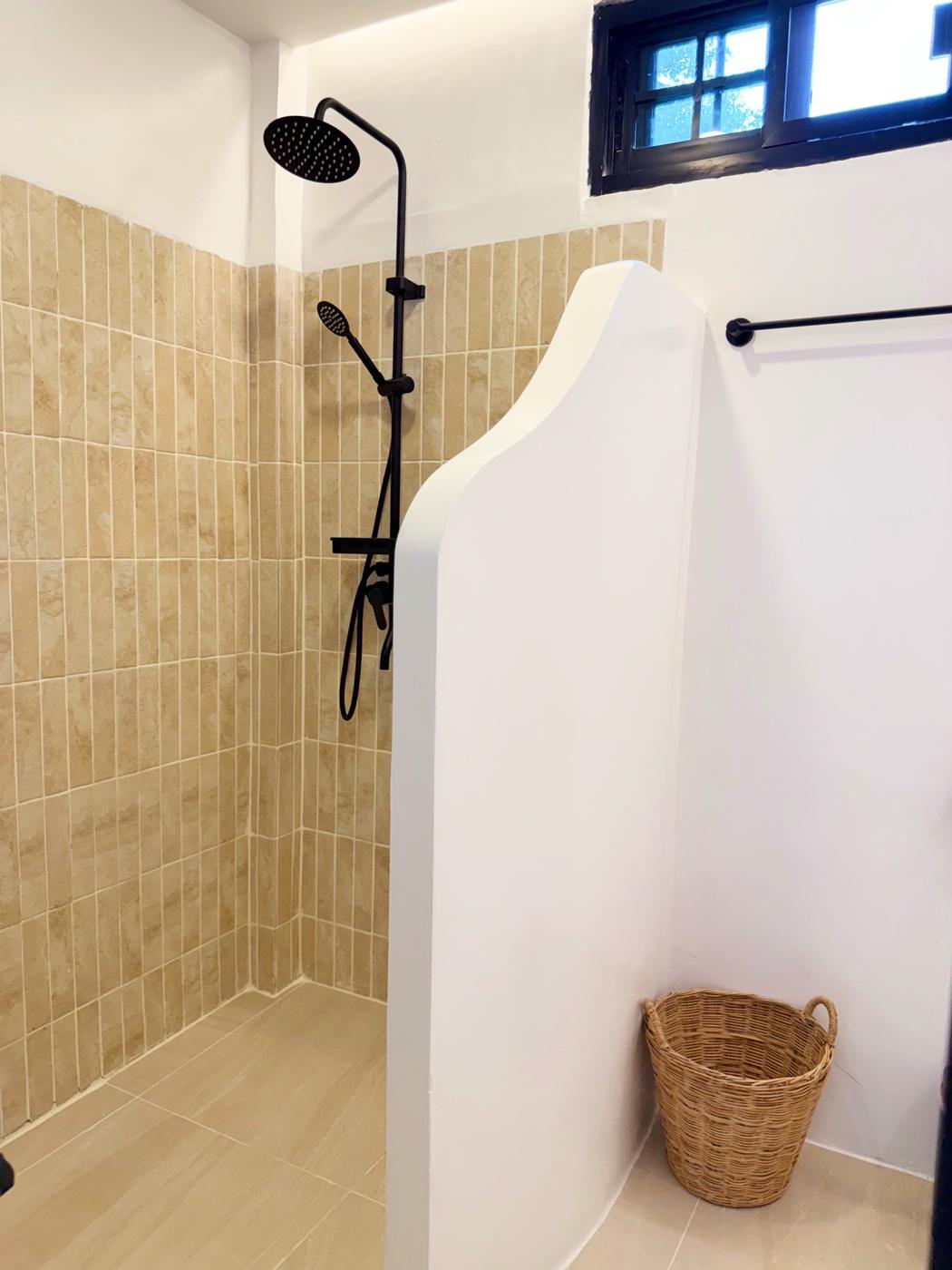 Walk-in rain shower with sand-colored tiles